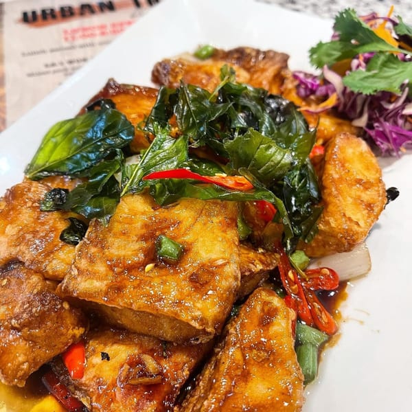 Crispy Thai fish fillets with basil, red chilies, and a side of purple cabbage salad.